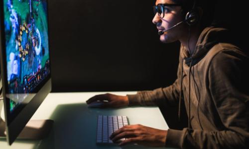 Indian man playing computer games